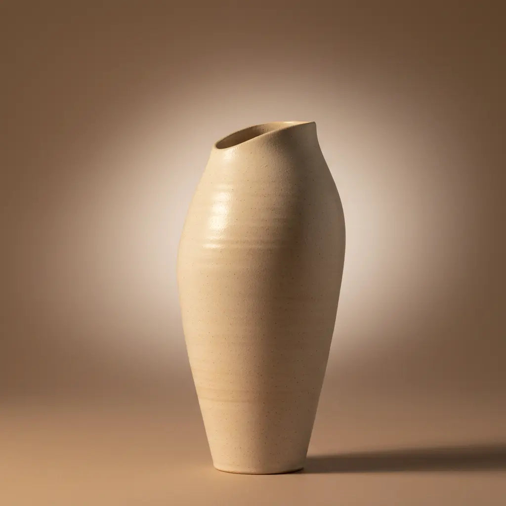 A minimalist studio scene featuring an elegant ceramic vase with subtle texture.