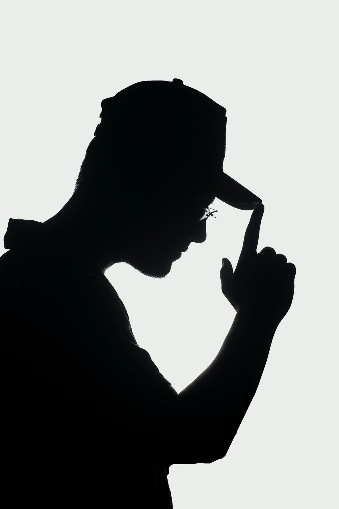 a silhouette of a man with a hat and glasses