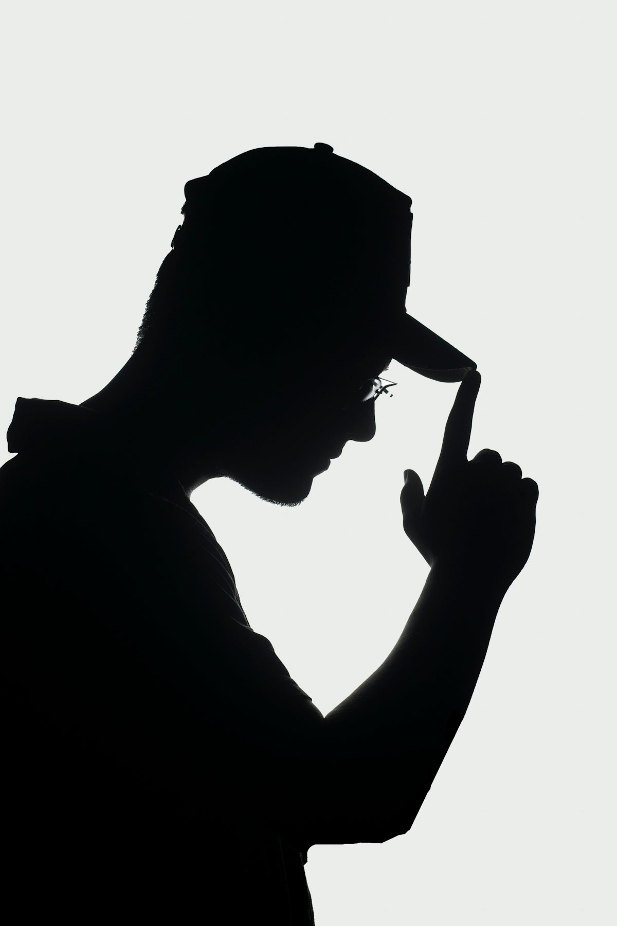 a silhouette of a man with a hat and glasses