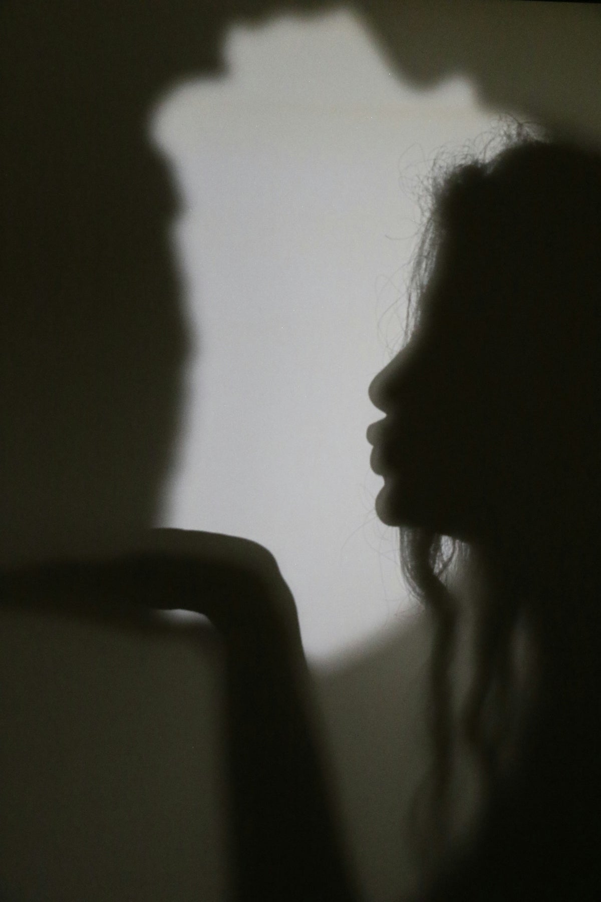 Silhouette of a woman blowing a kiss