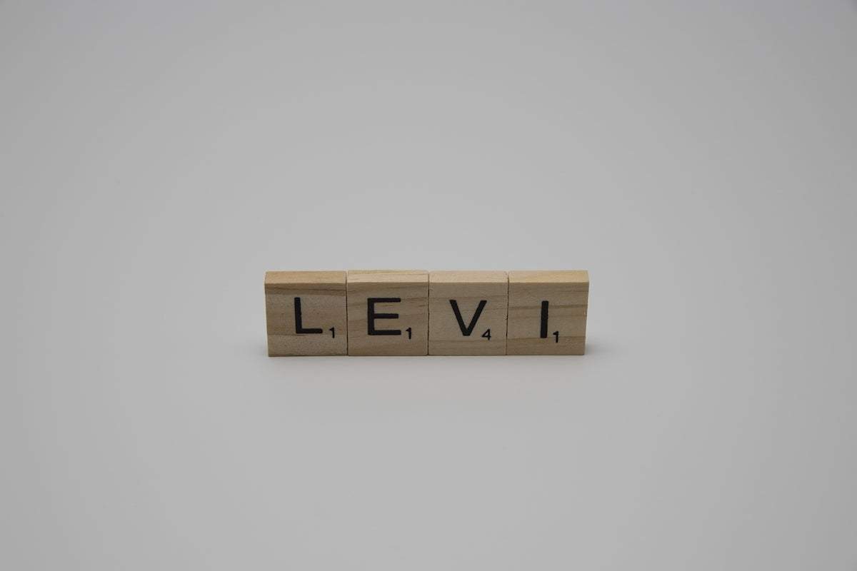 Scrabble tiles spell out the name levi.