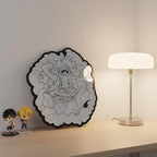 Frameless irregular floating mirror with manga Luffy artwork for stylish wall décor beside lamp and figurines.