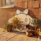 Bunny-shaped acrylic mirror displayed outdoors with potted plants