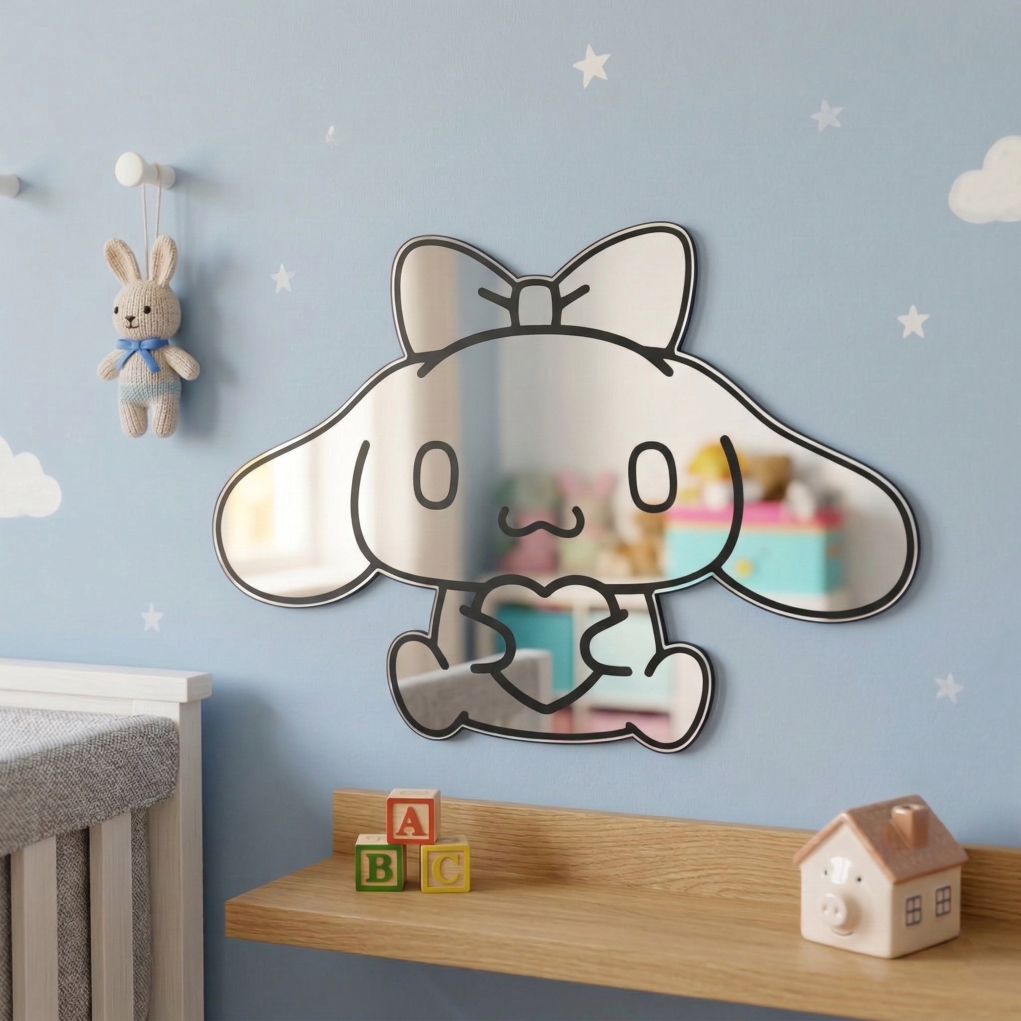Bunny-shaped acrylic mirror displayed outdoors with potted plants