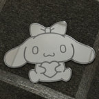 Bunny-shaped acrylic mirror displayed outdoors with potted plants