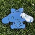 Bunny-shaped acrylic mirror displayed outdoors with potted plants