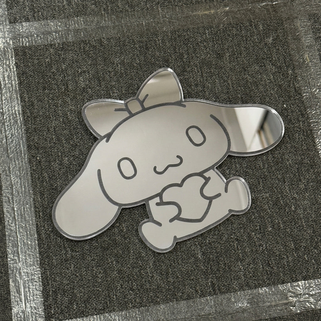 Bunny-shaped acrylic mirror displayed outdoors with potted plants